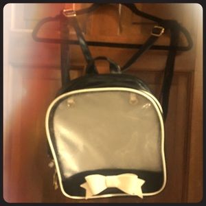 Black ita bag with white corset lacing